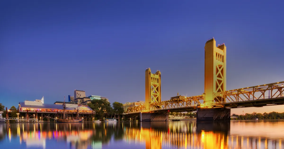 Sacramento skyline with the Tower Bridge and Capitol building at sunset